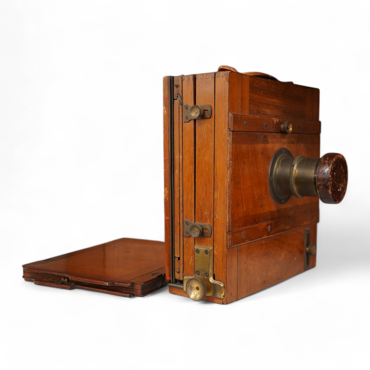 An early 20th century brass mounted mahogany full plate camera, together with a glass negative holder. Condition - fair to good.